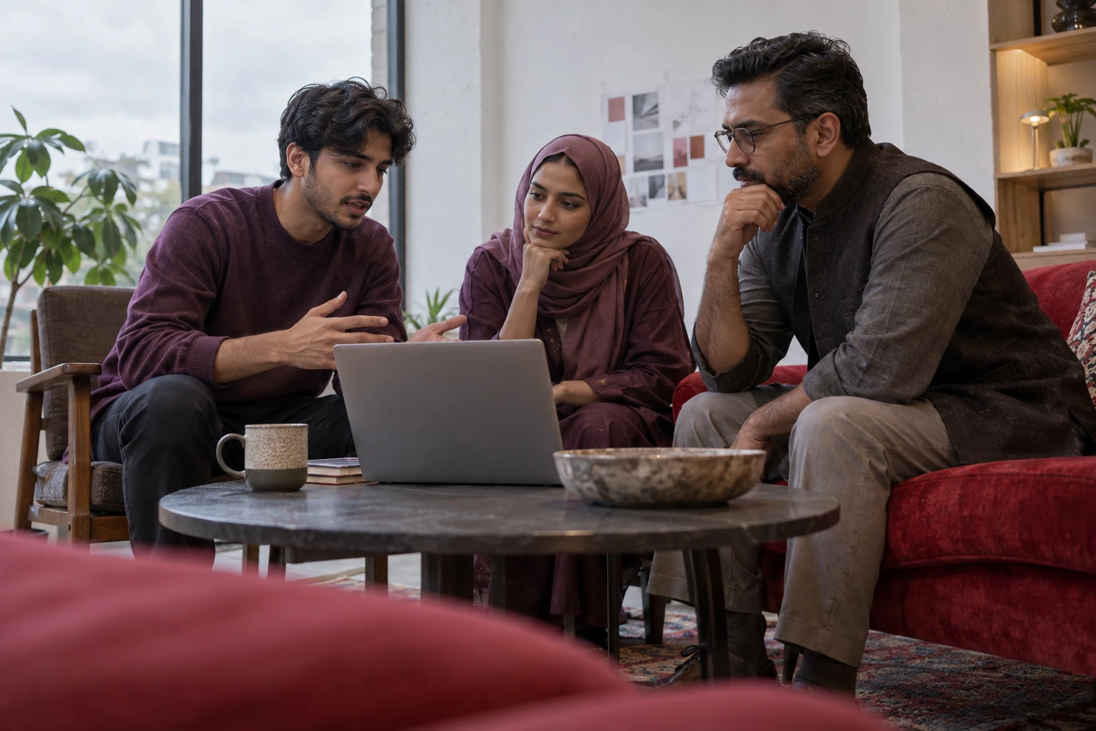 Illustrative scene: Three people discussing a proposed task around a laptop.